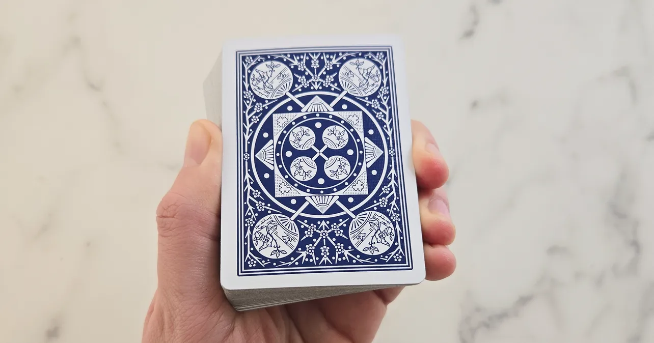Hand holding a deck of playing cards